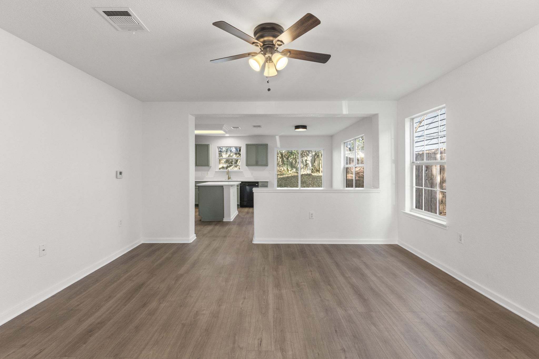 2110 Nogales Trail Austin, TX 78744 - Photo 6 of 36 Living room featuring dark wood-style floors and ceiling fan.