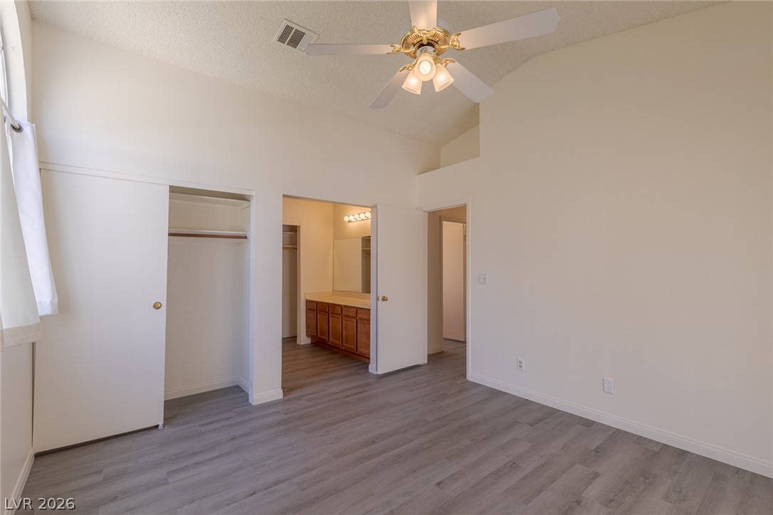 2803 Mirage Road Henderson, NV 89074 - Photo 19 of 39 High ceilings and durable wood-look flooring define this comfortable bedroom suite with an attached bath.