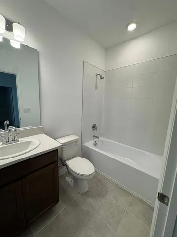 a bathroom with a double vanity sink toilet and shower
