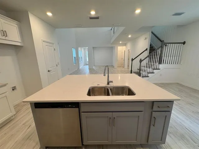 a kitchen with a sink and a refrigerator