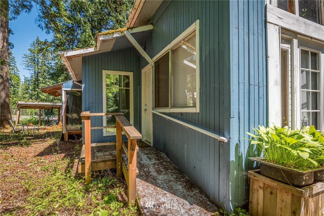 3031 Tower Road Maple Falls, WA 98266 - Photo 16 of 22 a balcony with table and chairs and a yard