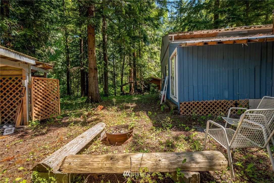 3031 Tower Road Maple Falls, WA 98266 - Photo 19 of 22 a view of a backyard with plants and wooden fence
