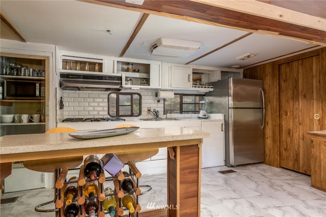 3031 Tower Road Maple Falls, WA 98266 - Photo 9 of 22 a kitchen with stainless steel appliances granite countertop a sink and a refrigerator
