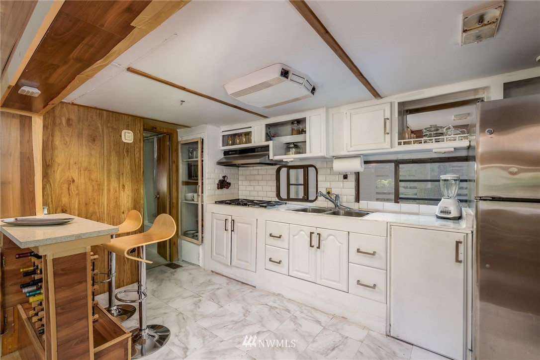 3031 Tower Road Maple Falls, WA 98266 - Photo 10 of 22 a kitchen with stainless steel appliances kitchen island granite countertop a sink and cabinets