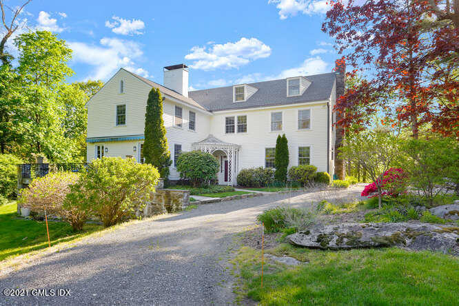75 Calhoun Drive Greenwich, CT 06831 - Photo 1 of 25 a front view of a house with garden