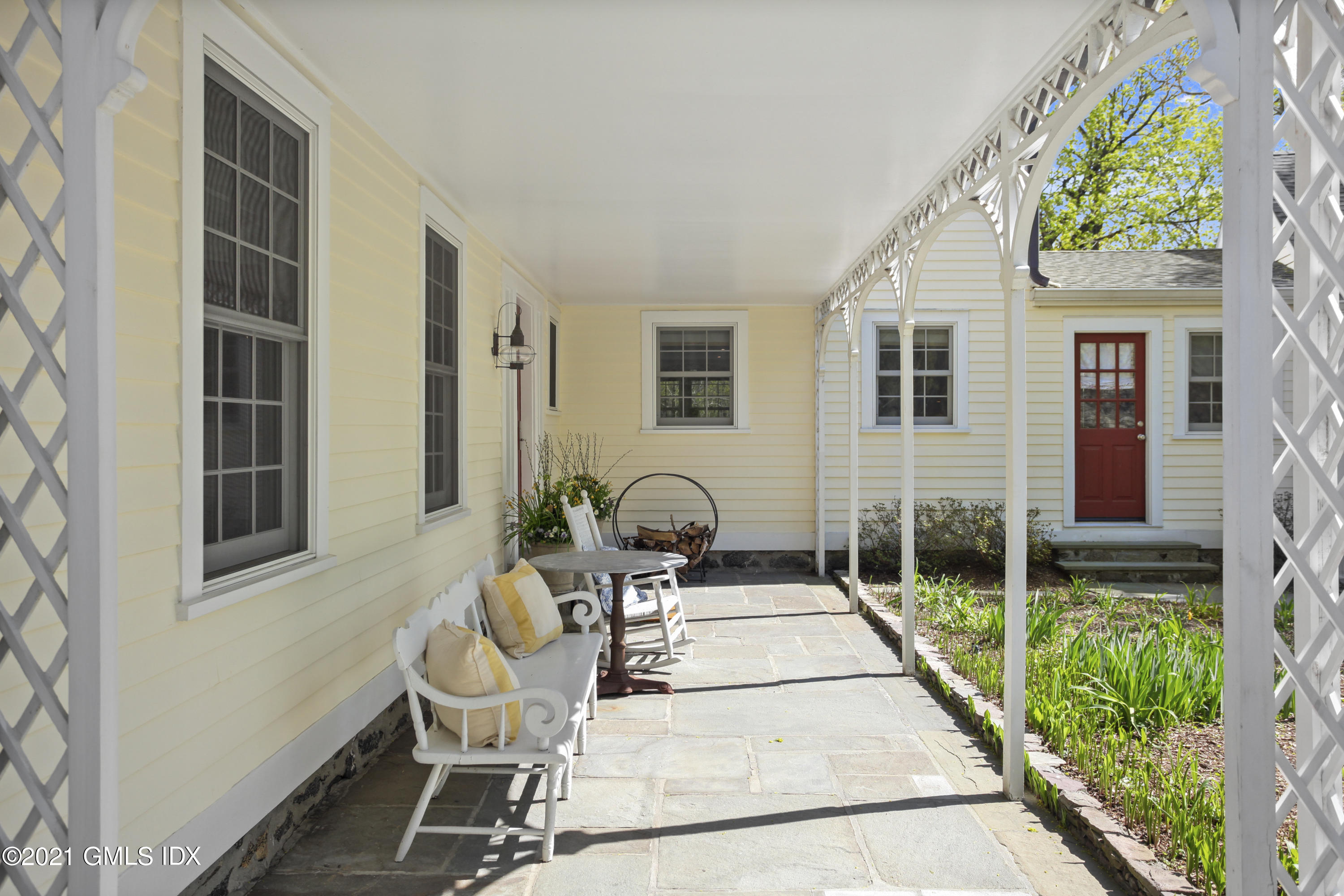 75 Calhoun Drive Greenwich, CT 06831 - Photo 22 of 25 a view of a patio with table and chairs and potted plants