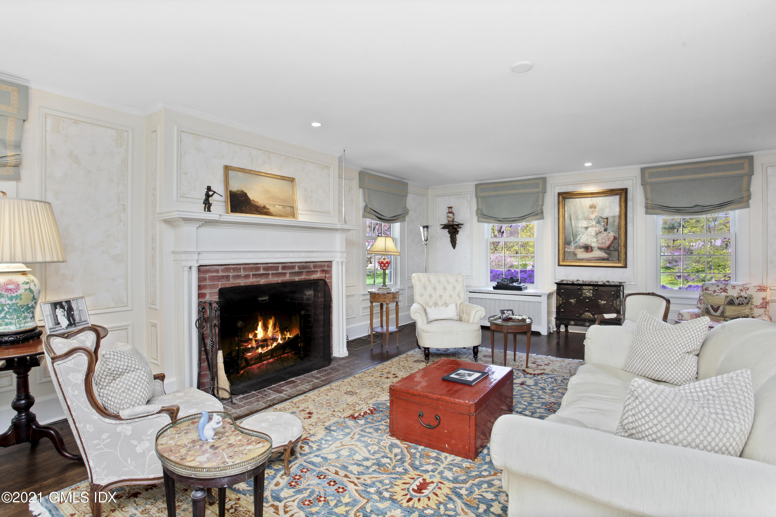 75 Calhoun Drive Greenwich, CT 06831 - Photo 3 of 25 a living room with furniture a fireplace and a table
