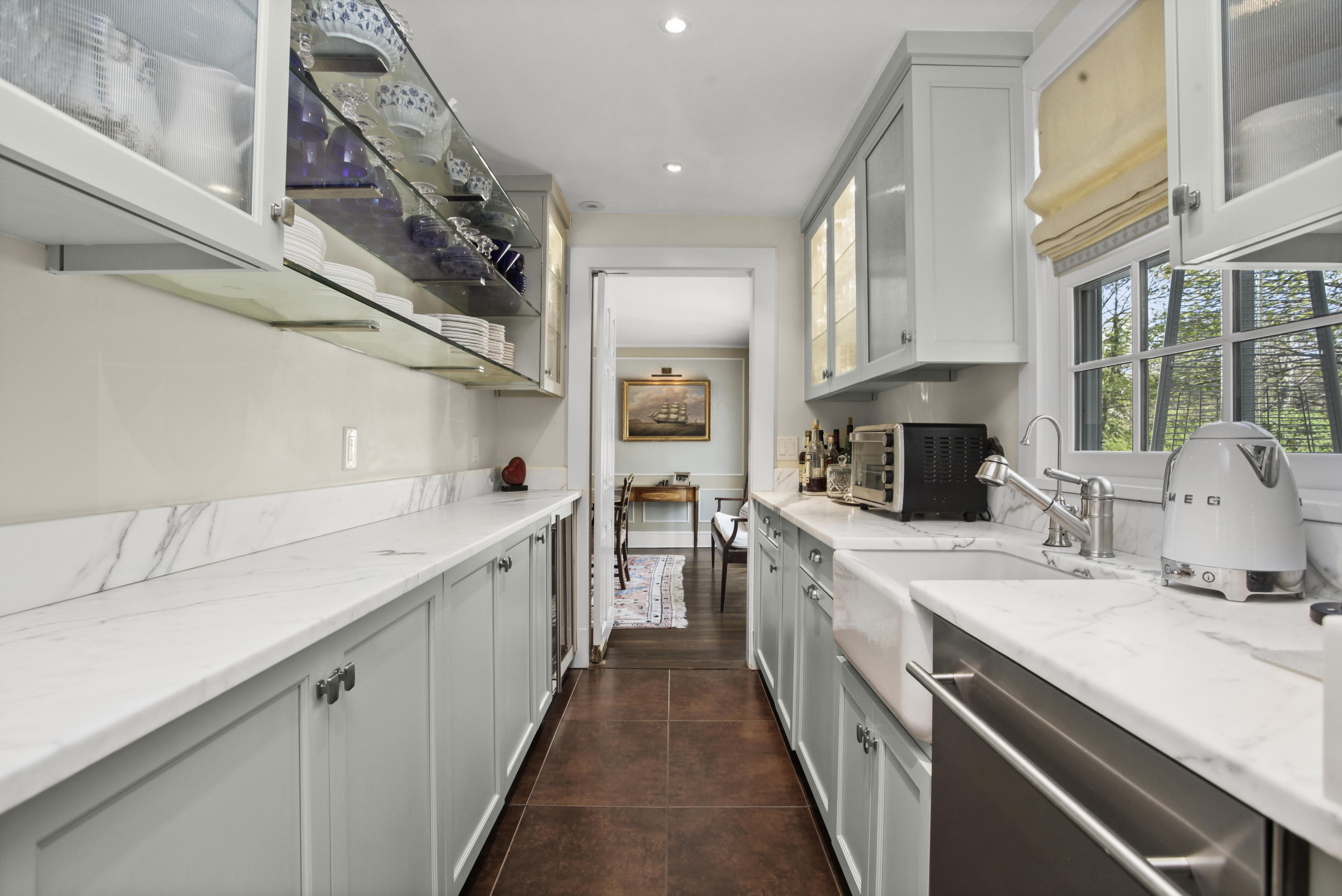 75 Calhoun Drive Greenwich, CT 06831 - Photo 5 of 25 a kitchen with a sink stove and cabinets