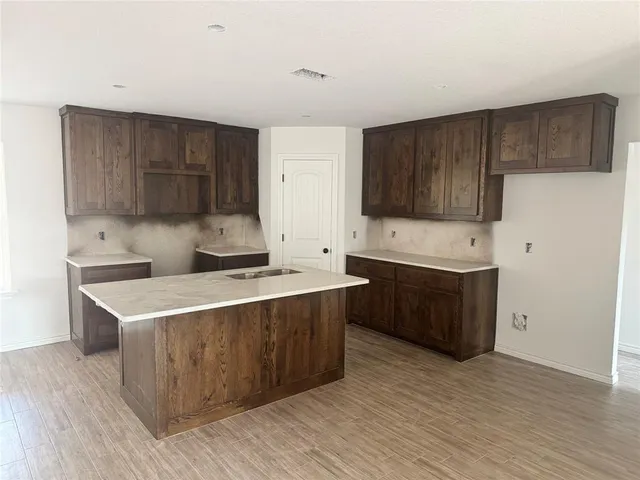 a kitchen with a sink and a stove top oven