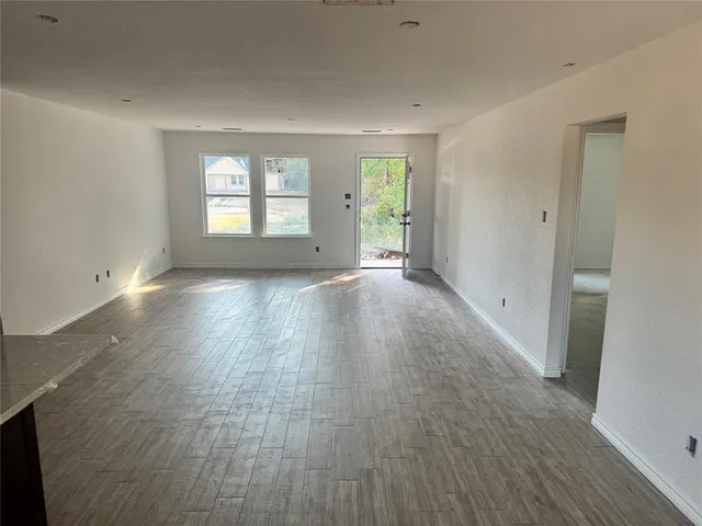 a view of a room with wooden floor and window