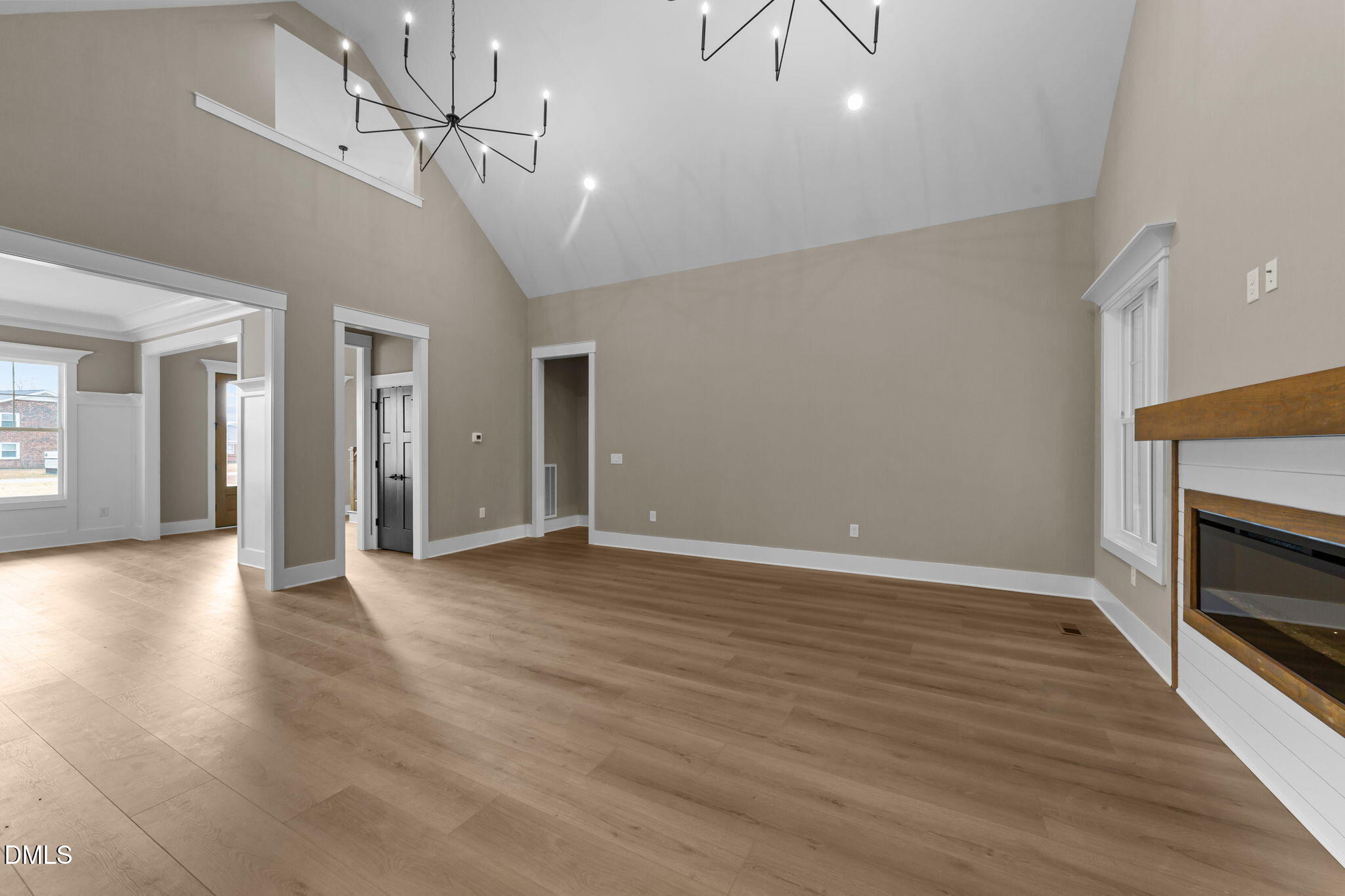 2590 Lassiter Road Four Oaks, NC 27524 - Photo 13 of 72 a view of an empty room with wooden floor fireplace and a window
