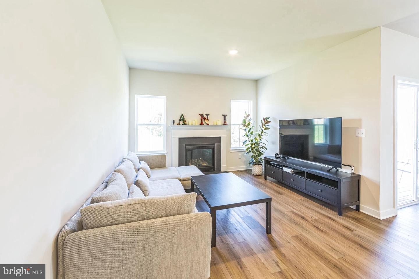 727 Hunsberger Road Spring City, PA 19475 - Photo 14 of 32 a living room with furniture a flat screen tv and a fireplace