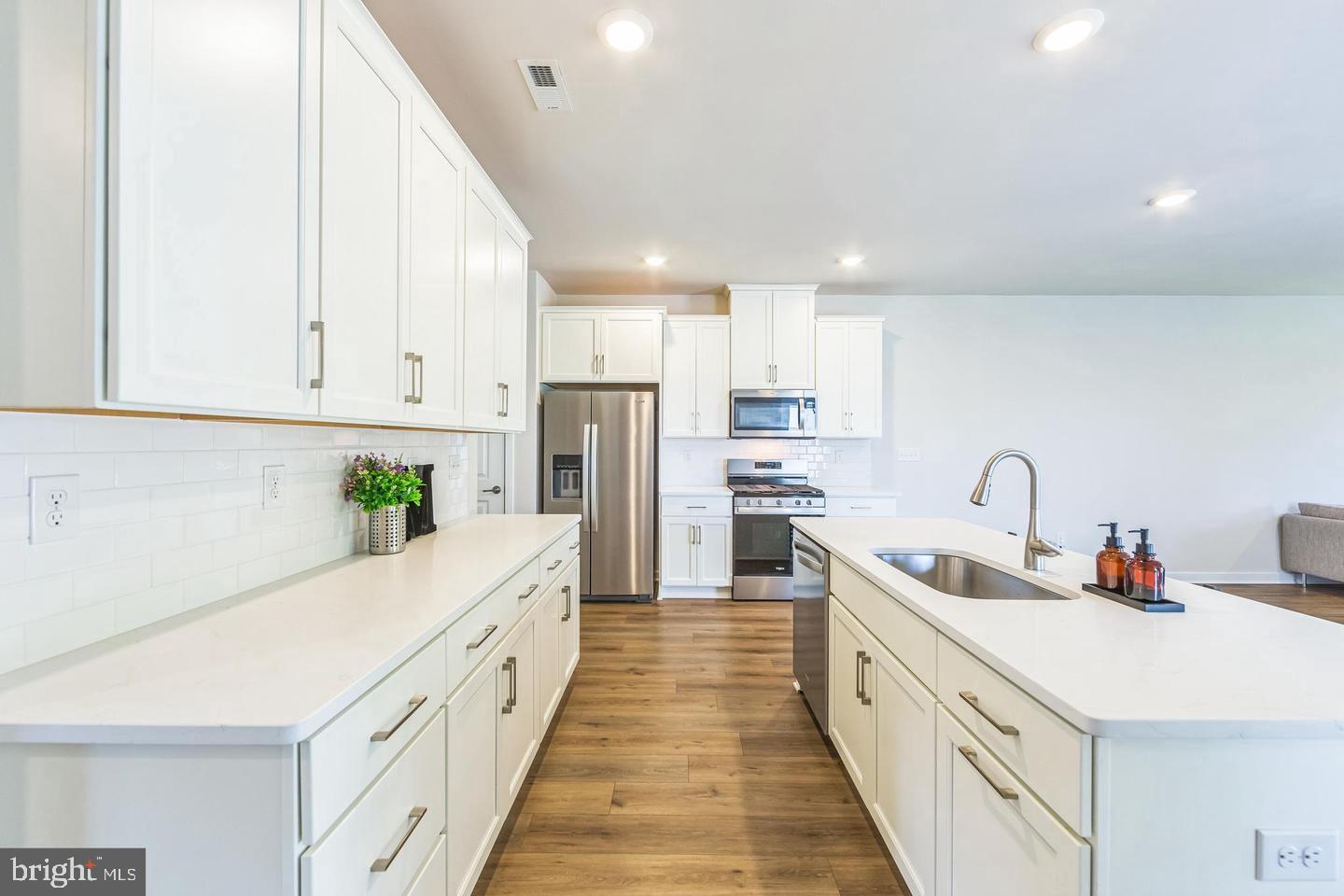 727 Hunsberger Road Spring City, PA 19475 - Photo 5 of 32 a large white kitchen with stainless steel appliances and white cabinets