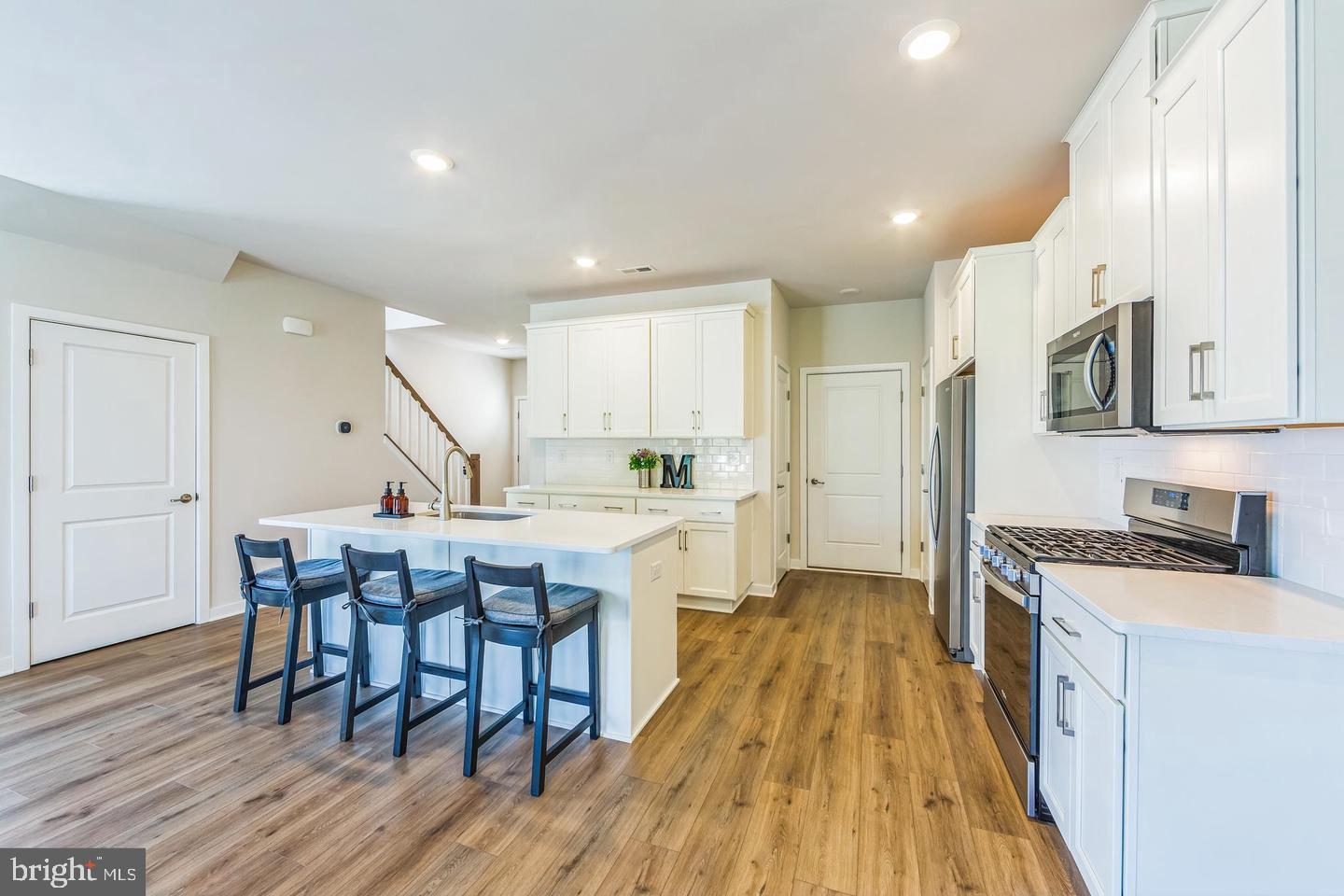 727 Hunsberger Road Spring City, PA 19475 - Photo 10 of 32 a kitchen with a wooden floor and white appliances