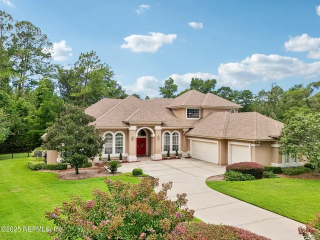 a view of a livingroom with furniture and floor to ceiling window
