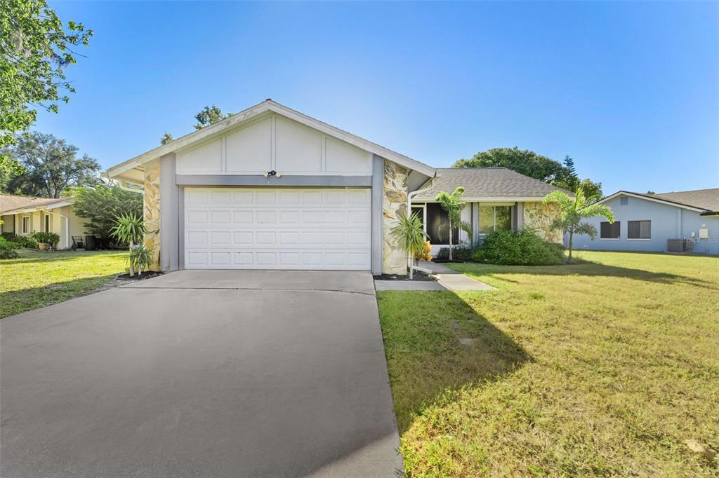a front view of a house with yard and green space