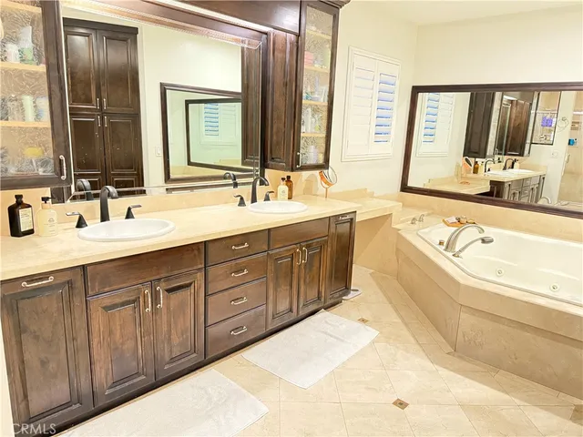 a large white kitchen with stainless steel appliances a refrigerator and a stove top oven