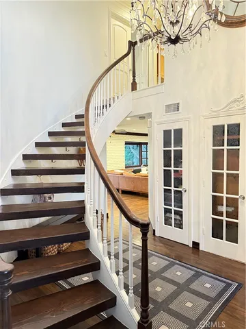 a view of entryway with wooden floor and stairs