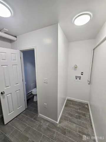 a view of a room with wooden floor and white doors