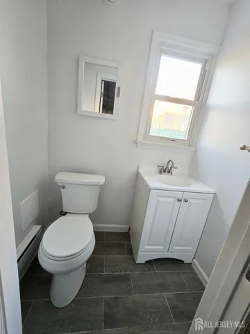 a white toilet sitting next to a bathroom sink