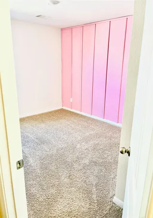 a view of bathroom and empty room