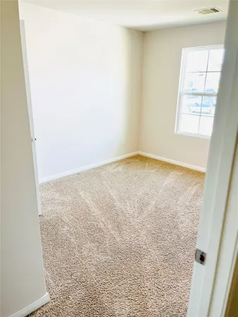 a view of empty room with windows