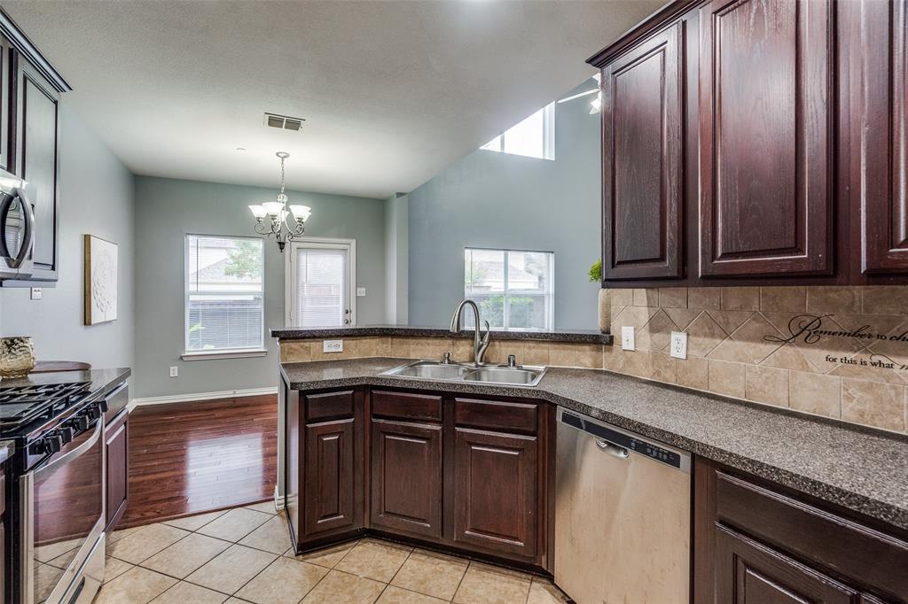 8738 Manhattan Avenue Plano, TX 75024 - Photo 11 of 22 a kitchen with stainless steel appliances granite countertop a sink stove and cabinets