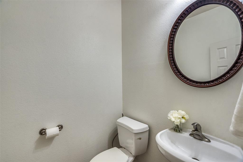 8738 Manhattan Avenue Plano, TX 75024 - Photo 13 of 22 a bathroom with a sink mirror and toilet