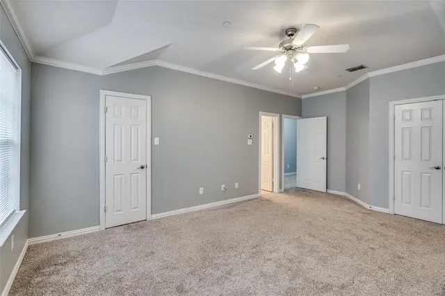 a view of an empty room with a ceiling fan