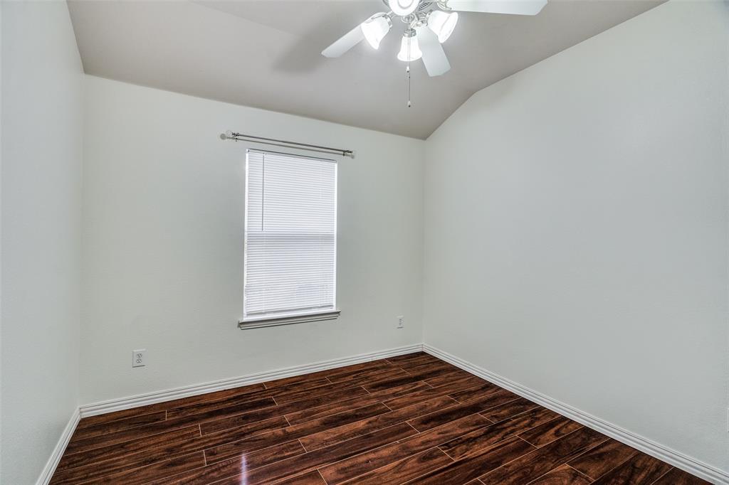 8738 Manhattan Avenue Plano, TX 75024 - Photo 18 of 22 a view of an empty room with wooden floor and a window