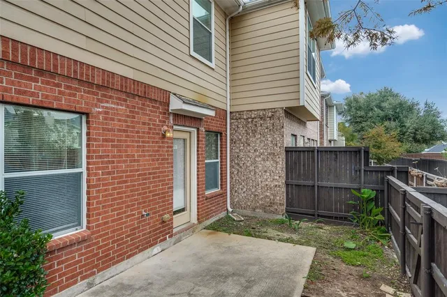 a view of a house with a backyard and wooden fence