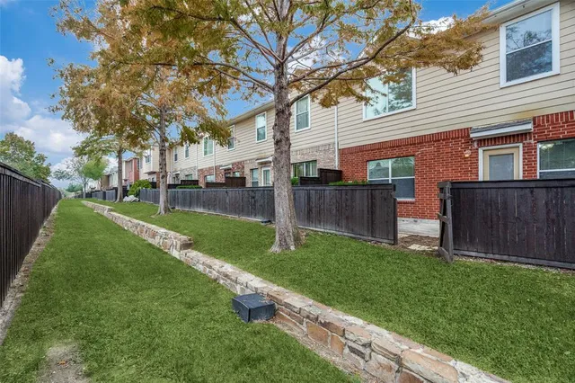 a view of a backyard with wooden fence