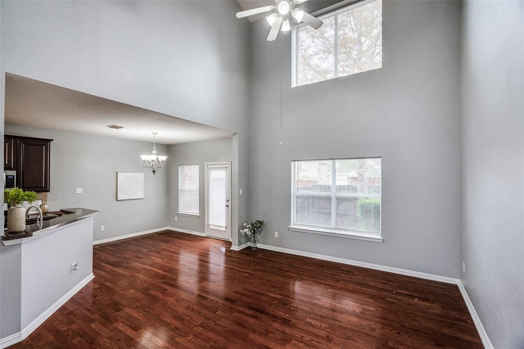 8738 Manhattan Avenue Plano, TX 75024 - Photo 4 of 22 an empty room with wooden floor and windows