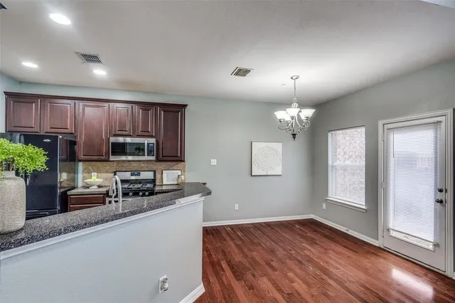 a kitchen with a refrigerator and a sink
