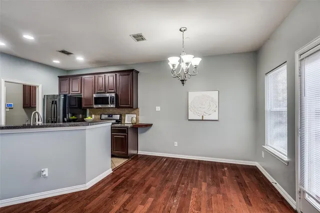 a view of kitchen with sink microwave and refrigerator