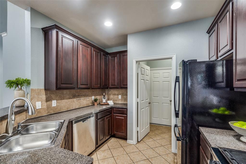 8738 Manhattan Avenue Plano, TX 75024 - Photo 10 of 22 a kitchen with stainless steel appliances granite countertop a refrigerator and a sink