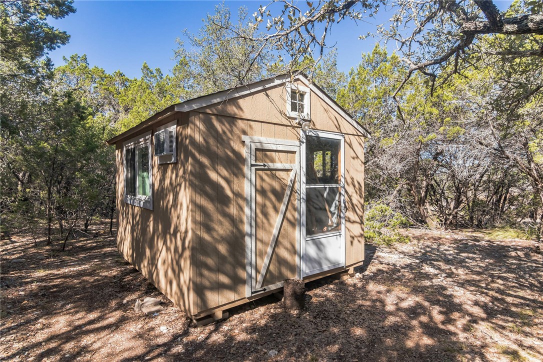 1000 Norwood Road Dripping Springs, TX 78620 - Photo 7 of 22 a house with trees in front of it