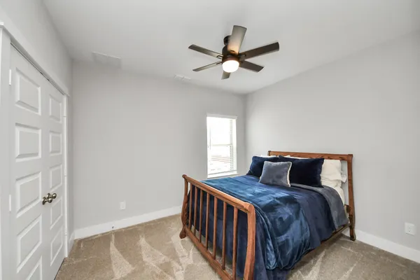a bedroom with a bed and window