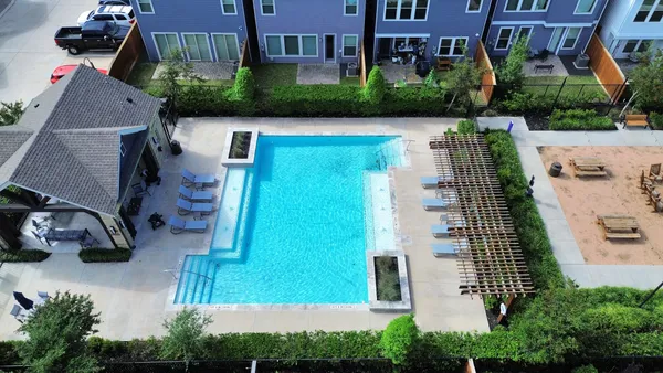 an aerial view of a house with a yard and fountain