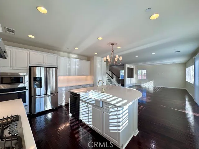 an empty room with wooden floor and window
