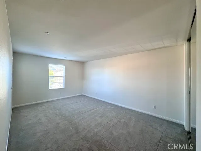 a large white kitchen with a large window