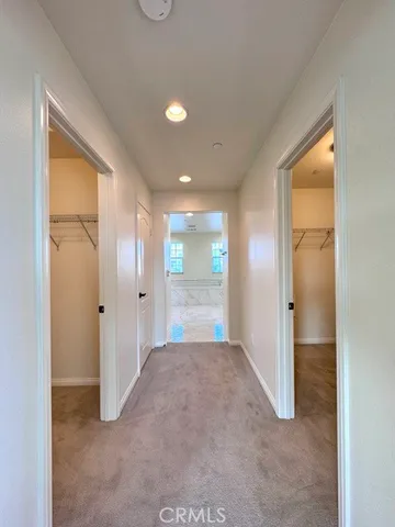 a view of a porch with lots of potted plants and a garage