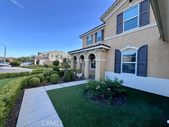 a front view of a house with a garden