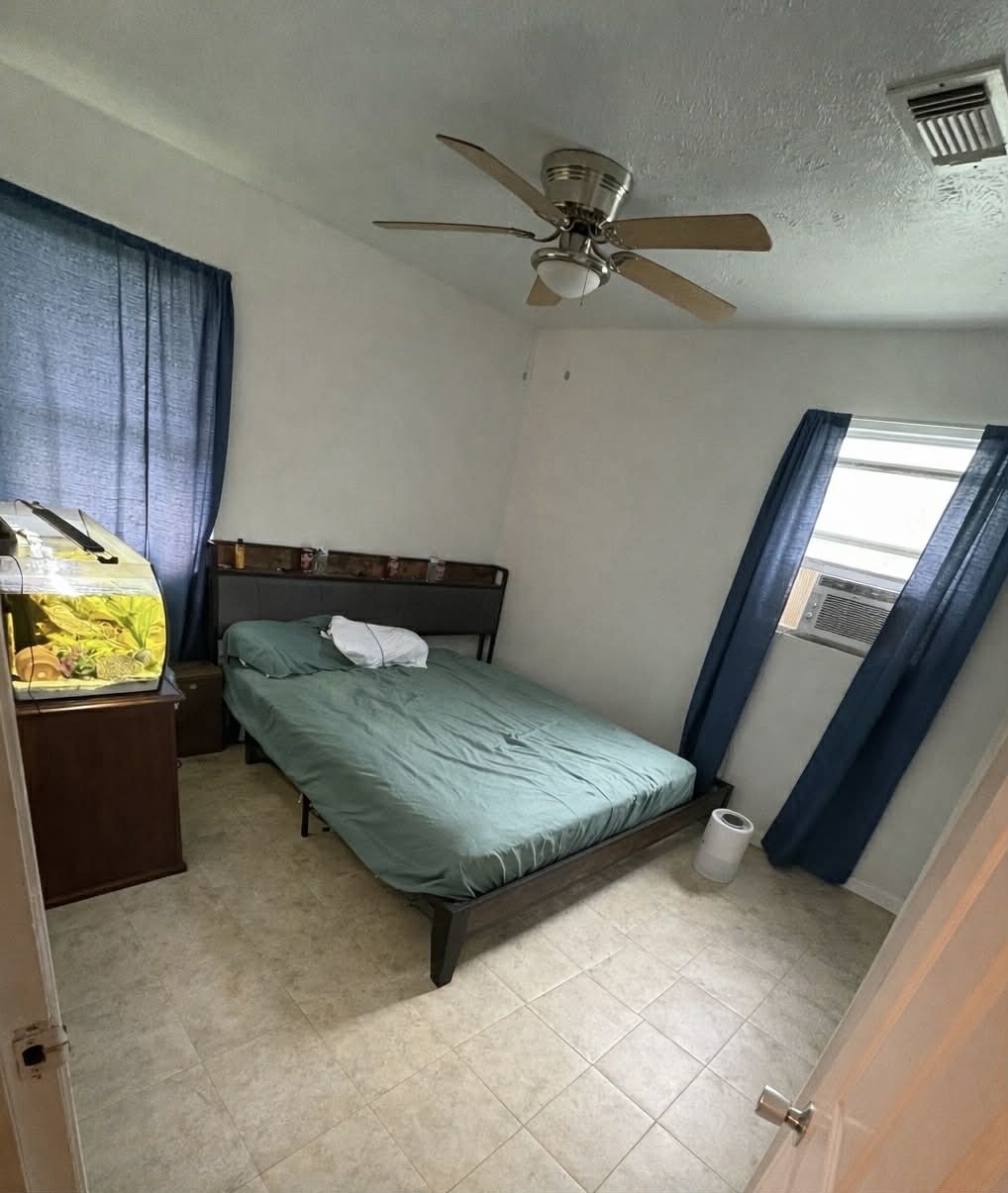 61 Hooker Shepherd, TX 77371 - Photo 10 of 17 a bedroom with a bed and ceiling fan