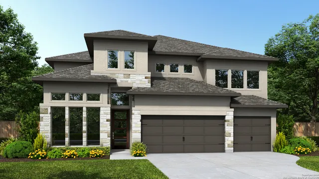 a front view of a house with a garden and yard