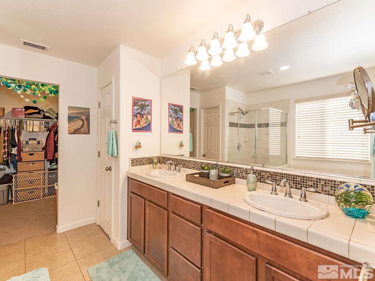 2030 Angel Ridge Drive Reno, NV 89521 - Photo 18 of 22 a spacious bathroom with a granite countertop sink a mirror and shower