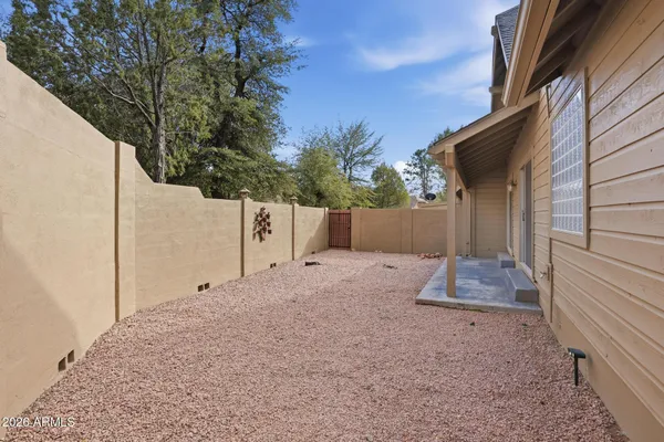 a swimming pool with outdoor seating and garden