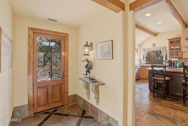 a kitchen with stainless steel appliances granite countertop a sink and a granite counter tops with a large window