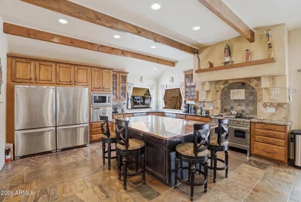 a kitchen with a stove a sink and a refrigerator