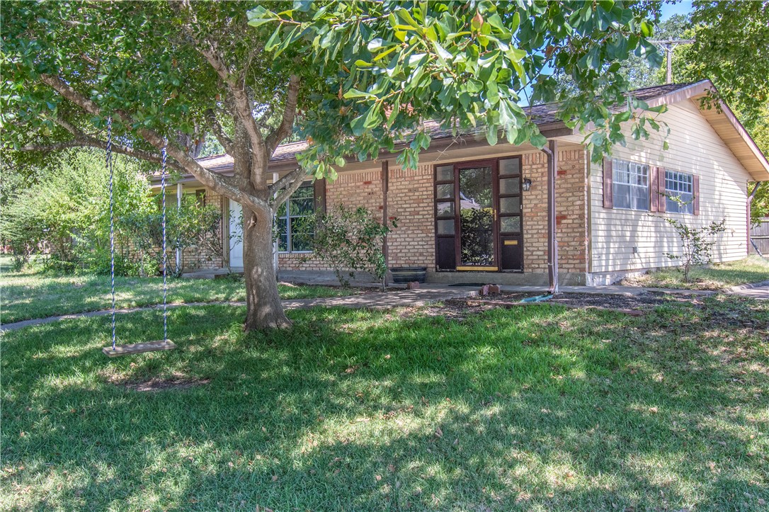a view of a house with backyard garden and sitting area